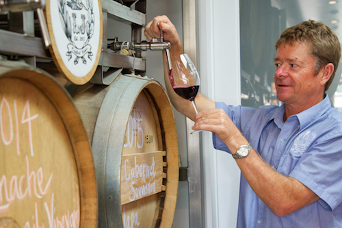 Lowel Jooste filling a wine glass with his patented wine barrel tap